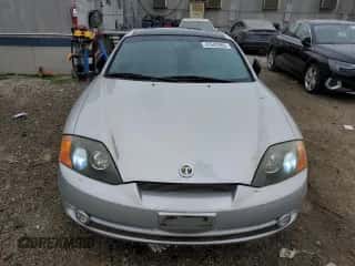 2003 Hyundai Tiburon GT z VIN KMHHN65F03U079618, wystawiony jako Copart lot #47642965 z przebiegiem 87 483 mil mil oraz Czysty tytuł • Clean title. Historia ofert i sprzedaży dostępna na DreamBid. Obrazek 5.
