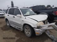 ✅ 2003 Suzuki Grand Vitara • VIN: JS3TE62VX34100454 • Lot: 43839370. Listed on IAAI with 198,777 mi. Free auction sales archive from the USA and detailed vehicle history report at DreamBid. Image 1.