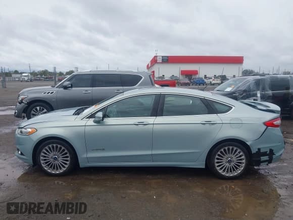 ✅ 2014 Ford Fusion Titanium Hybrid • VIN: 3FA6P0RU8ER350016 • Lot: 43532622. Listed on IAAI with 87,458 mi. Free auction sales archive from the USA and detailed vehicle history report at DreamBid. Image 14.