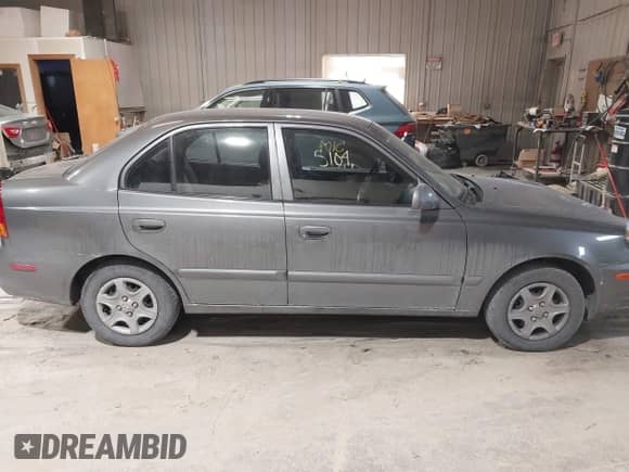 2004 Hyundai Accent GL z VIN KMHCG45C44U528783, wystawiony jako IAAI lot #41535104 z przebiegiem Nie podano mil oraz . Historia ofert i sprzedaży dostępna na DreamBid. Obrazek 13.