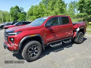 ✅ 2023 GMC Canyon 4WD AT4X • VIN: 1GTP6EEK7P1221085 • Лот: 62527455. Опубликован ранее на Copart с пробегом 10 355 миль. Бесплатный доступ к архиву аукционных продаж из США и подробный отчёт об истории автомобиля на DreamBid. Изображение 1.