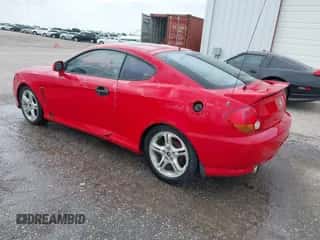 2003 Hyundai Tiburon GT z VIN KMHHN65F13U069681, wystawiony jako IAAI lot #42317725 z przebiegiem 219 002 mil mil oraz . Historia ofert i sprzedaży dostępna na DreamBid. Obrazek 3.