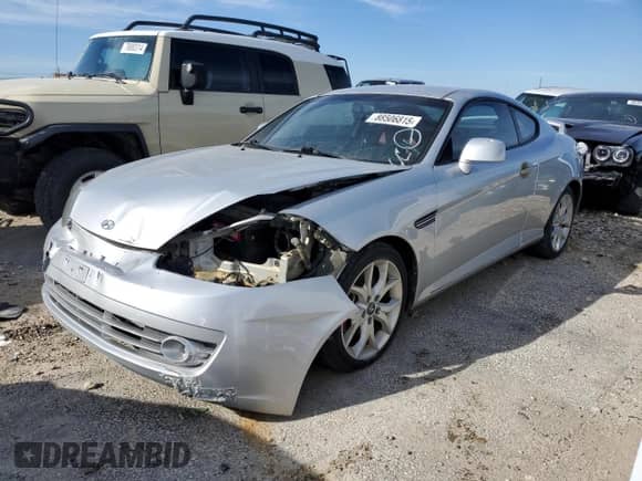 2008 Hyundai Tiburon GT z VIN KMHHN66F98U267849, wystawiony jako Copart lot #88506815 z przebiegiem 92 820 mil mil oraz Szkoda całkowita • Salvage title. Historia ofert i sprzedaży dostępna na DreamBid. Obrazek 1.