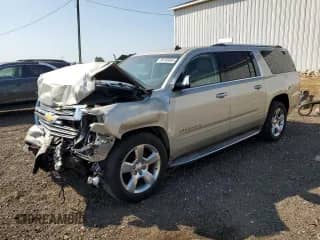 2015 Chevrolet Suburban LTZ z VIN 1GNSKKKC8FR245890, wystawiony jako Copart lot #80150495 z przebiegiem 216 132 mil mil oraz Czysty tytuł • Clean title. Historia ofert i sprzedaży dostępna na DreamBid. Obrazek 1.