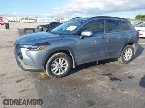 ✅ 2023 Toyota Corolla Cross LE • VIN: 7MUCAAAG7PV064903 • Lot: 43584375. Listed on IAAI with 28,011 mi. Free auction sales archive from the USA and detailed vehicle history report at DreamBid. Image 2.