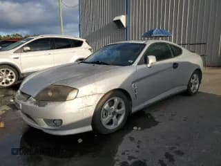 ✅ 2006 Hyundai Tiburon GS • VIN: KMHHM65D06U205823 • Лот: 87125445. Опубликован ранее на Copart с пробегом 158 410 миль. Бесплатный доступ к архиву аукционных продаж из США и подробный отчёт об истории автомобиля на DreamBid. Изображение 1.