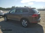 ✅ 2013 Volkswagen Touareg Lux • VIN: WVGEF9BP6DD013932 • Lot: 62047945. Listed on Copart with 127,821 mi. Free auction sales archive from the USA and detailed vehicle history report at DreamBid. Image 2.