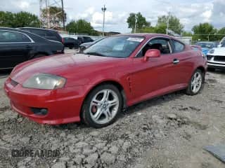 2005 Hyundai Tiburon GT z VIN KMHHN65F25U160235, wystawiony jako Copart lot #83780185 z przebiegiem 209 095 mil mil oraz Nie do naprawy • Non repairable. Historia ofert i sprzedaży dostępna na DreamBid. Obrazek 1.