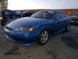 2005 Hyundai Tiburon GS z VIN KMHHM65D65U183681, wystawiony jako Copart lot #86779914 z przebiegiem 190 575 mil mil oraz Czysty tytuł • Clean title. Historia ofert i sprzedaży dostępna na DreamBid. Obrazek 1.