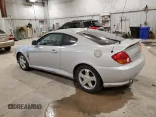 2004 Hyundai Tiburon с VIN KMHHM65D04U131767, выставлен на аукционе Copart как лот 81593054 с пробегом 67 235 миль миль и Чистый • Clean title. История ставок и продаж доступна на DreamBid. Изображение 2.