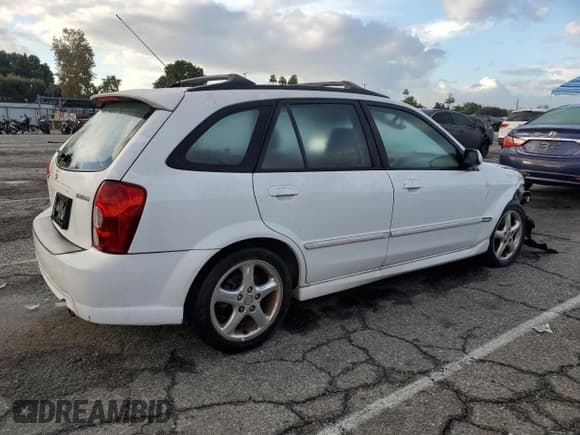 ✅ 2002 Mazda Protege • VIN: JM1BJ245121567998 • Lot: 92867455. Listed on Copart with 134,851 mi. Free auction sales archive from the USA and detailed vehicle history report at DreamBid. Image 3.