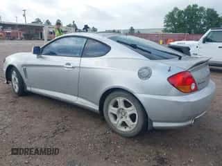2003 Hyundai Tiburon GT z VIN KMHHN65F63U036899, wystawiony jako IAAI lot #42148935 z przebiegiem 203 485 mil mil oraz . Historia ofert i sprzedaży dostępna na DreamBid. Obrazek 3.