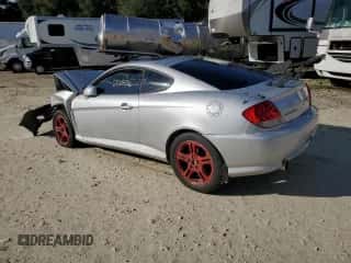 2006 Hyundai Tiburon GT z VIN KMHHN65F96U224661, wystawiony jako Copart lot #76643653 z przebiegiem 200 436 mil mil oraz Szkoda całkowita • Salvage title. Historia ofert i sprzedaży dostępna na DreamBid. Obrazek 2.