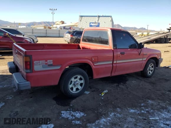 ✅ 1987 Mazda B-Series SE5 • VIN: JM2UF1114H0546272 • Лот: 89002935. Опубликован ранее на Copart с пробегом 108 979 миль. Бесплатный доступ к архиву аукционных продаж из США и подробный отчёт об истории автомобиля на DreamBid. Изображение 3.