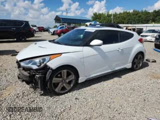 2014 Hyundai Veloster Turbo z VIN KMHTC6AEXEU207122, wystawiony jako Copart lot #65622345 z przebiegiem 154 471 mil mil oraz Czysty tytuł • Clean title. Historia ofert i sprzedaży dostępna na DreamBid. Obrazek 1.