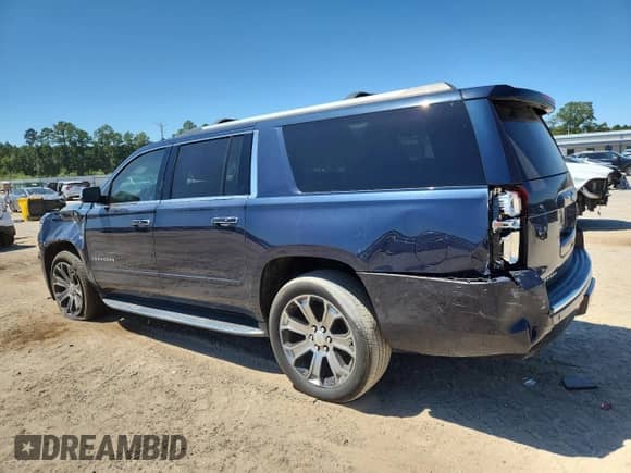 2019 Chevrolet Suburban Premier with VIN 1GNSCJKCXKR110511, listed as a Copart auction lot 71028945 with 87,669 mi miles and Salvage title. Bid and sale history available at DreamBid. Image 2.