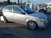 ✅ 2010 Kia Rio LX • VIN: KNADH4A38A6673706 • Lot: 43645629. Listed on IAAI with 145,094 mi. Free auction sales archive from the USA and detailed vehicle history report at DreamBid. Image 1.