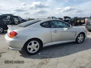 ✅ 2003 Hyundai Tiburon GT • VIN: KMHHN65F03U055237 • Лот: 82400615. Опубликован ранее на Copart с пробегом 244 468 миль. Бесплатный доступ к архиву аукционных продаж из США и подробный отчёт об истории автомобиля на DreamBid. Изображение 3.