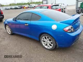 2008 Hyundai Tiburon GT z VIN KMHHN66FX8U282926, wystawiony jako IAAI lot #41959023 z przebiegiem 119 414 mil mil oraz . Historia ofert i sprzedaży dostępna na DreamBid. Obrazek 3.