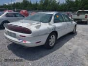 ✅ 1999 Oldsmobile Aurora • VIN: 1G3GR62CXX4100897 • Lot: 42277912. Wystawiony na IAAI z przebiegiem 179 680 mil. Bezpłatny archiwum sprzedaży aukcyjnych z USA i szczegółowy raport historii pojazdu na DreamBid. Zdjęcie 4.