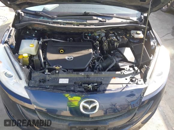 ✅ 2015 Mazda 5 Sport • VIN: JM1CW2BL7F0182965 • Lot: 43606712. Listed on IAAI with 150,777 mi. Free auction sales archive from the USA and detailed vehicle history report at DreamBid. Image 10.