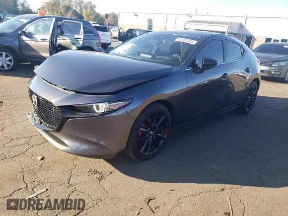 ✅ 2021 Mazda 3 2.5 Turbo • VIN: JM1BPBJY6M1312215 • Лот: 87062285. Опубликован ранее на Copart с пробегом 64 283 миль. Бесплатный доступ к архиву аукционных продаж из США и подробный отчёт об истории автомобиля на DreamBid. Изображение 1.