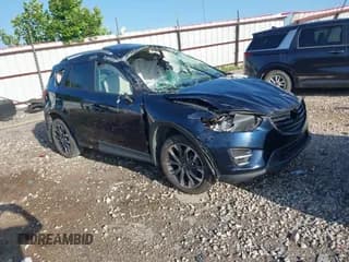 ✅ 2016 Mazda CX-5 Grand Touring • VIN: JM3KE2DY9G0708447 • Lot: 42613443. Wystawiony na IAAI z przebiegiem 123 478 mil. Bezpłatny archiwum sprzedaży aukcyjnych z USA i szczegółowy raport historii pojazdu na DreamBid. Zdjęcie 1.