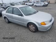 ✅ 2000 Mazda Protege DX • VIN: JM1BJ2225Y0211691 • Lot: 42464257. Listed on IAAI with 176,457 mi. Free auction sales archive from the USA and detailed vehicle history report at DreamBid. Image 1.