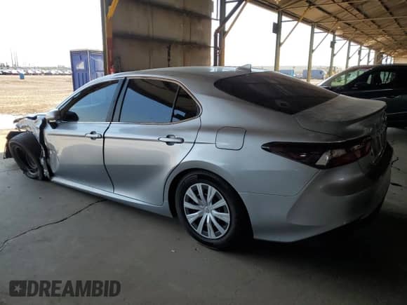 2021 Toyota Camry Hybrid LE with VIN 4T1C31AK5MU554381, listed as a Copart auction lot 69998775 with 104,313 mi miles and Salvage title. Bid and sale history available at DreamBid. Image 2.