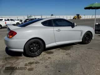 2003 Hyundai Tiburon GT с VIN KMHHN65F73U101856, выставлен на аукционе Copart как лот 64248815 с пробегом 59 622 миль миль и Списание • Salvage title. История ставок и продаж доступна на DreamBid. Изображение 3.