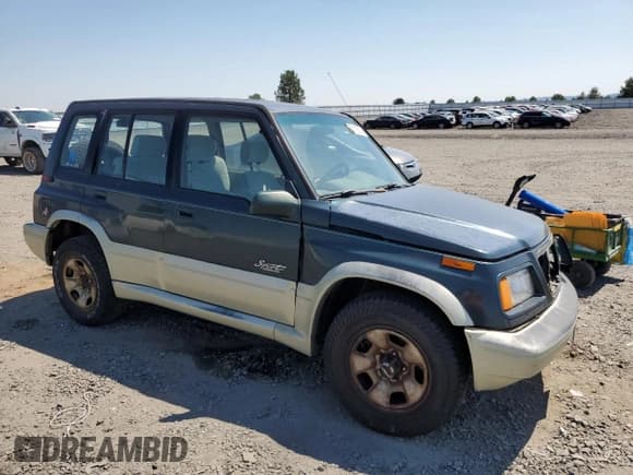 ✅ 1998 Suzuki Sidekick • VIN: JS3TD21V9W4103914 • Lot: 62112514. Listed on Copart with 394,872 mi. Free auction sales archive from the USA and detailed vehicle history report at DreamBid. Image 4.