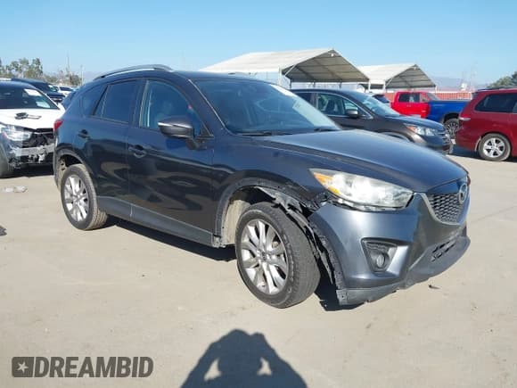 ✅ 2015 Mazda CX-5 Grand Touring • VIN: JM3KE4DY4F0471893 • Lot: 43526634. Wystawiony na IAAI z przebiegiem 159 277 mil. Bezpłatny archiwum sprzedaży aukcyjnych z USA i szczegółowy raport historii pojazdu na DreamBid. Zdjęcie 1.