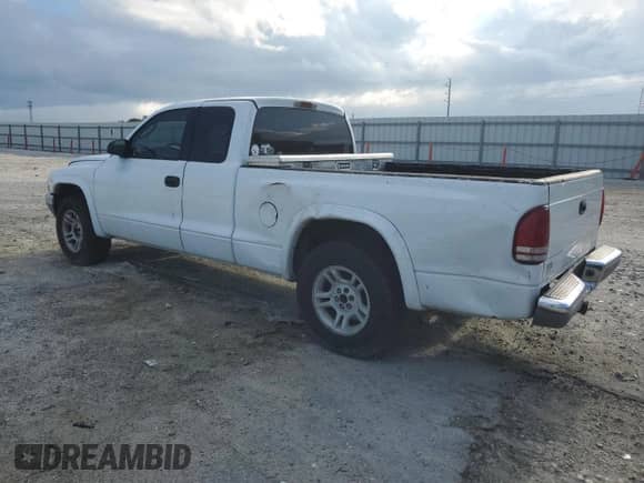 2002 Dodge Dakota SLT с VIN 1B7GL42N72S593692, выставлен на аукционе Copart как лот 69221245 с пробегом 141 599 миль миль и Списание • Salvage title. История ставок и продаж доступна на DreamBid. Изображение 2.