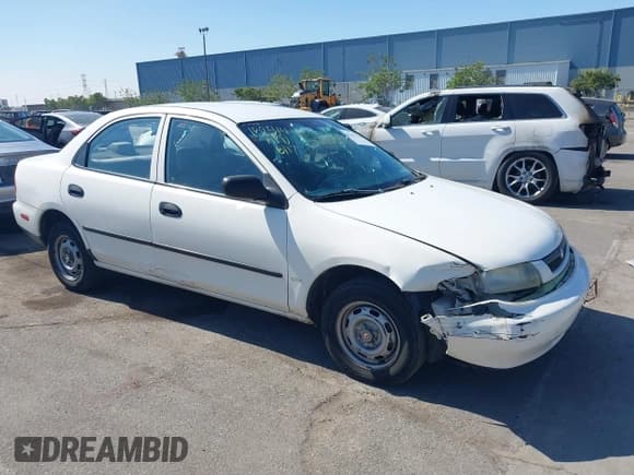 ✅ 1997 Mazda Protege DX • VIN: JM1BC1415V0101406 • Lot: 40932010. Wystawiony na IAAI z przebiegiem 164 899 mil. Bezpłatny archiwum sprzedaży aukcyjnych z USA i szczegółowy raport historii pojazdu na DreamBid. Zdjęcie 1.