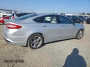 ✅ 2016 Ford Fusion Titanium Hybrid • VIN: 3FA6P0RU0GR127178 • Лот: 94665415. Опубликован ранее на Copart с пробегом 141 144 миль. Бесплатный доступ к архиву аукционных продаж из США и подробный отчёт об истории автомобиля на DreamBid. Изображение 3.
