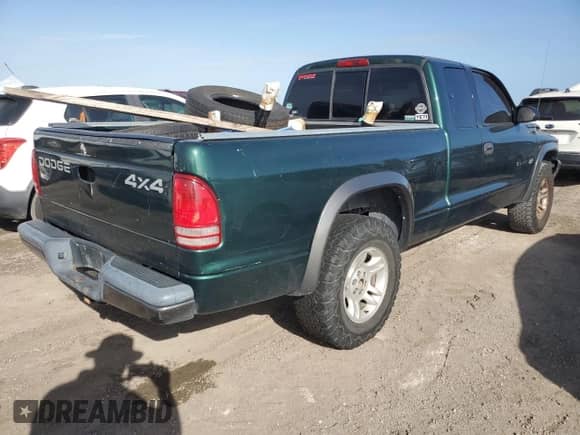 2002 Dodge Dakota z VIN 1B7GG12X52S705975, wystawiony jako Copart lot #75224734 z przebiegiem 150 441 mil mil oraz Szkoda całkowita • Salvage title. Historia ofert i sprzedaży dostępna na DreamBid. Obrazek 3.