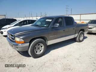 2001 Dodge Dakota Sport z VIN 1B7HL2AN61S301927, wystawiony jako Copart lot #74676094 z przebiegiem 228 616 mil mil oraz Szkoda całkowita • Salvage title. Historia ofert i sprzedaży dostępna na DreamBid. Obrazek 1.