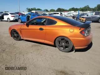 2006 Hyundai Tiburon GT z VIN KMHHN65FX6U221882, wystawiony jako Copart lot #57456825 z przebiegiem 203 312 mil mil oraz Szkoda całkowita • Salvage title. Historia ofert i sprzedaży dostępna na DreamBid. Obrazek 2.