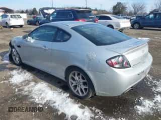 2007 Hyundai Tiburon GT z VIN KMHHN66F97U250757, wystawiony jako IAAI lot #41363768 z przebiegiem 95 365 mil mil oraz . Historia ofert i sprzedaży dostępna na DreamBid. Obrazek 3.