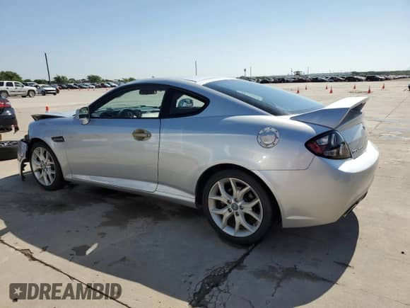2008 Hyundai Tiburon GT z VIN KMHHN66F98U267849, wystawiony jako Copart lot #88506815 z przebiegiem 92 820 mil mil oraz Szkoda całkowita • Salvage title. Historia ofert i sprzedaży dostępna na DreamBid. Obrazek 2.