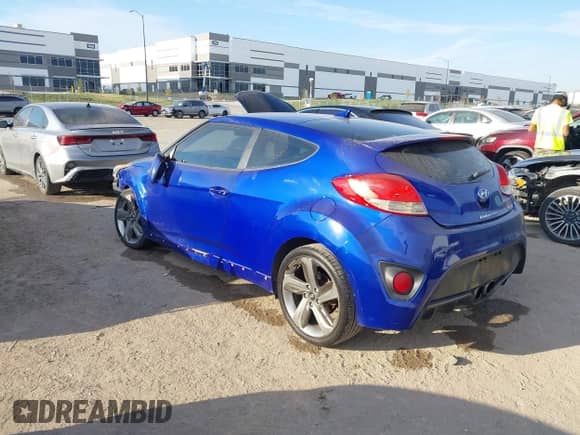 2014 Hyundai Veloster Turbo z VIN KMHTC6AE4EU184467, wystawiony jako IAAI lot #43457856 z przebiegiem 149 546 mil mil oraz . Historia ofert i sprzedaży dostępna na DreamBid. Obrazek 3.