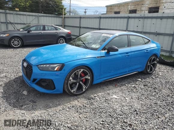 ✅ 2021 Audi RS 5 Sportback • VIN: WUAAWCF5XMA902567 • Лот: 55143235. Опубликован ранее на Copart с пробегом 13 800 миль. Бесплатный доступ к архиву аукционных продаж из США и подробный отчёт об истории автомобиля на DreamBid. Изображение 1.