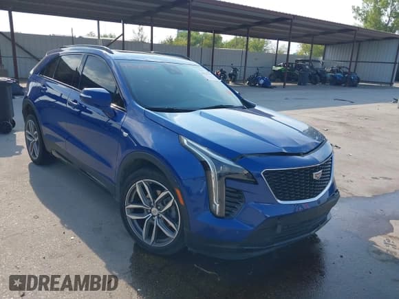 ✅ 2023 Cadillac XT4 FWD Sport • VIN: 1GYFZER40PF104167 • Лот: 43211356. Опубликован ранее на IAAI с пробегом 28 524 миль. Бесплатный доступ к архиву аукционных продаж из США и подробный отчёт об истории автомобиля на DreamBid. Изображение 1.