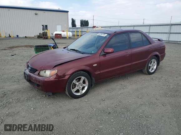 ✅ 2003 Mazda Protege DX • VIN: JM1BJ225930126453 • Лот: 80286785. Опубликован ранее на Copart с пробегом 106 034 миль. Бесплатный доступ к архиву аукционных продаж из США и подробный отчёт об истории автомобиля на DreamBid. Изображение 1.