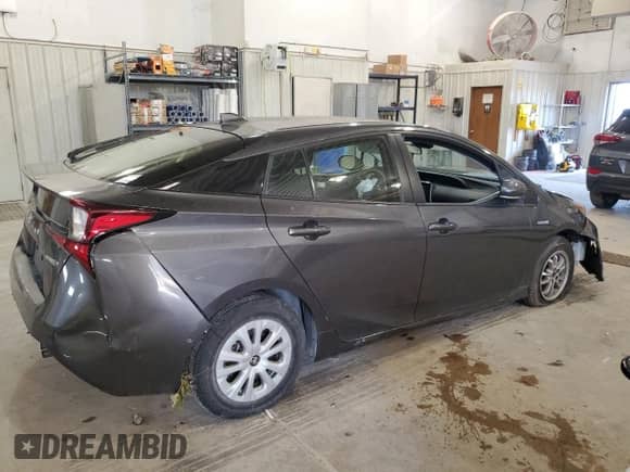 2021 Toyota Prius L Eco с VIN JTDKAMFU5M3143781, выставлен на аукционе Copart как лот 81028565 с пробегом 52 355 миль миль и Списание • Salvage title. История ставок и продаж доступна на DreamBid. Изображение 3.