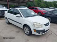 ✅ 2009 Kia Rio LX • VIN: KNADE223096557455 • Lot: 42432576. Listed on IAAI with 155,523 mi. Free auction sales archive from the USA and detailed vehicle history report at DreamBid. Image 1.