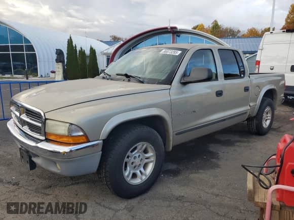 2002 Dodge Dakota SLT z VIN 1B7HL48X02S720473, wystawiony jako Copart lot #86873285 z przebiegiem 74 633 mil mil oraz Czysty tytuł • Clean title. Historia ofert i sprzedaży dostępna na DreamBid. Obrazek 1.