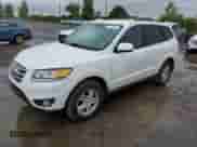 2012 Hyundai Santa Fe GLS z VIN 5XYZGDAG3CG166338, wystawiony jako Copart lot #73139004 z przebiegiem 124 377 mil mil oraz Czysty tytuł • Clean title. Historia ofert i sprzedaży dostępna na DreamBid. Obrazek 1.