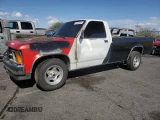 1987 Dodge Dakota z VIN 1B7GN14M2HS362897, wystawiony jako Copart lot #57639085 z przebiegiem Nie podano mil oraz Szkoda całkowita • Salvage title. Historia ofert i sprzedaży dostępna na DreamBid. Obrazek 1.