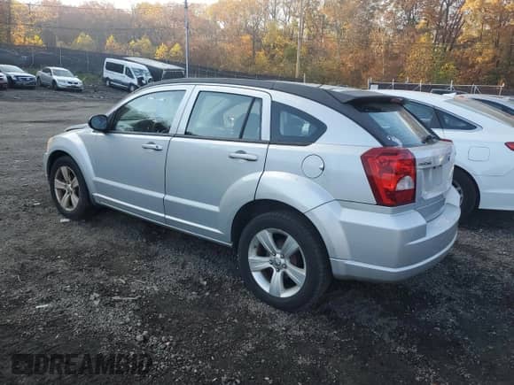 2011 Dodge Caliber Mainstreet with VIN 1B3CB3HA3BD123701, listed as a Copart auction lot 90858485 with 172,631 mi miles and Salvage title. Bid and sale history available at DreamBid. Image 2.